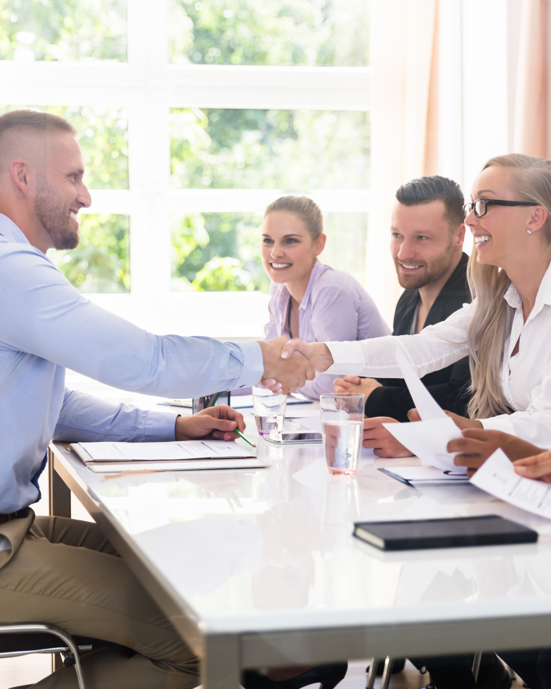 federal panel interview prospect shaking hands of federal panel interviewer