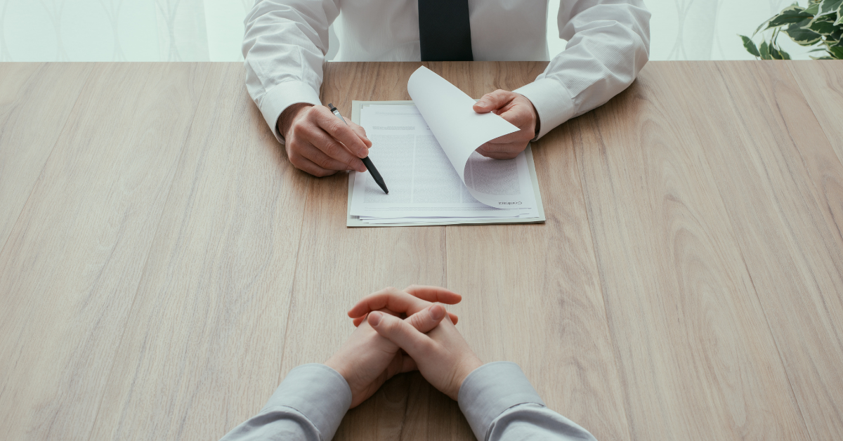 job interviewer reviewing resume job interviewer reviewing resume with former federal worker