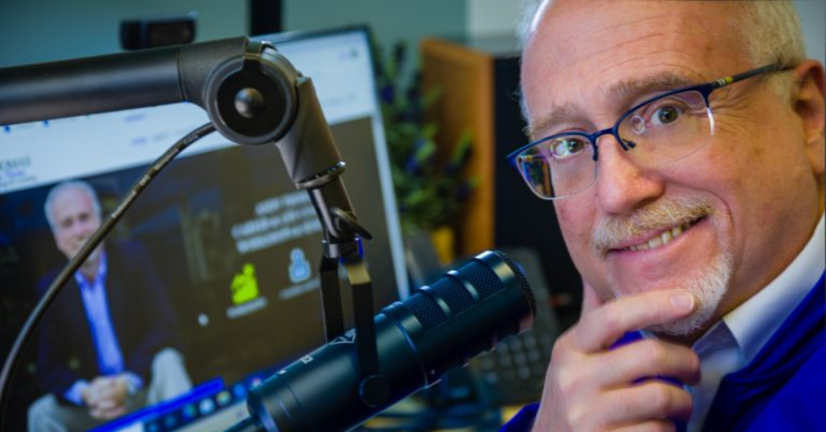 andy thomas with microphone smiling into camera after virtual executive coaching session
