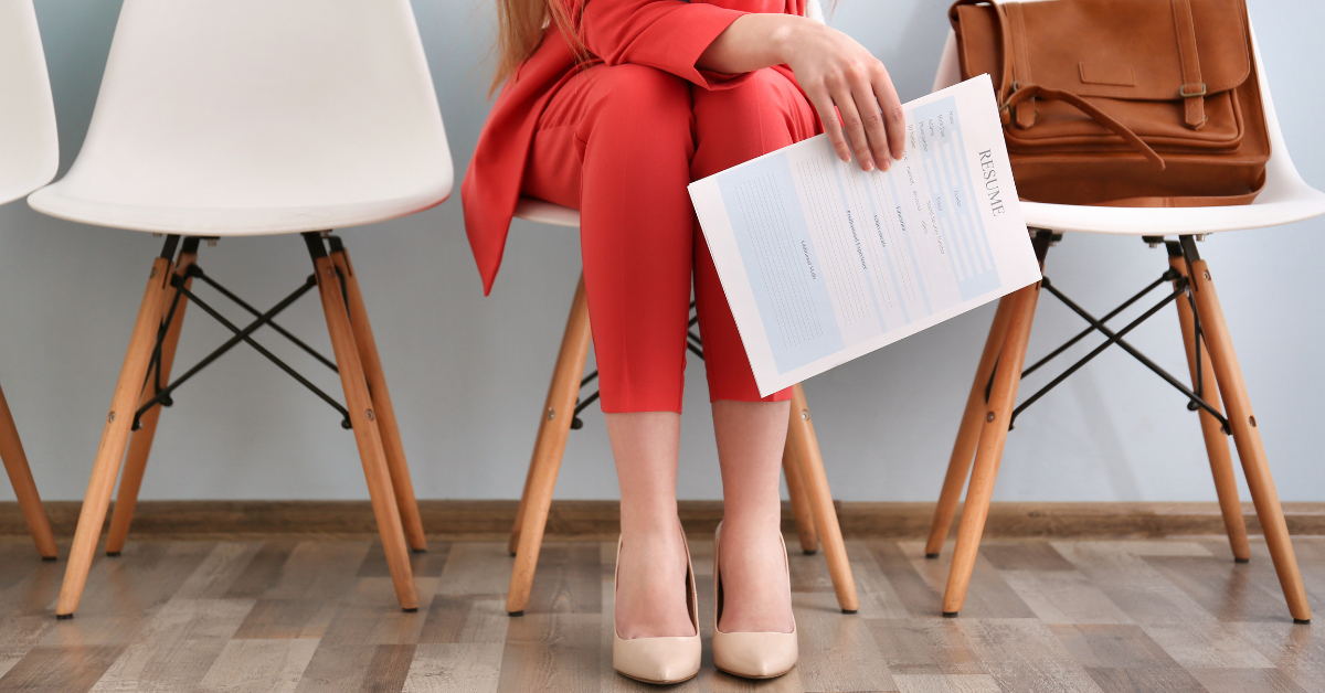 woman waiting for interview with resume in hand