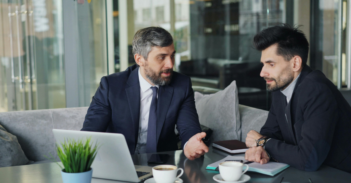 one-on-one executive coaching session in a modern office setting with a senior leader and coach