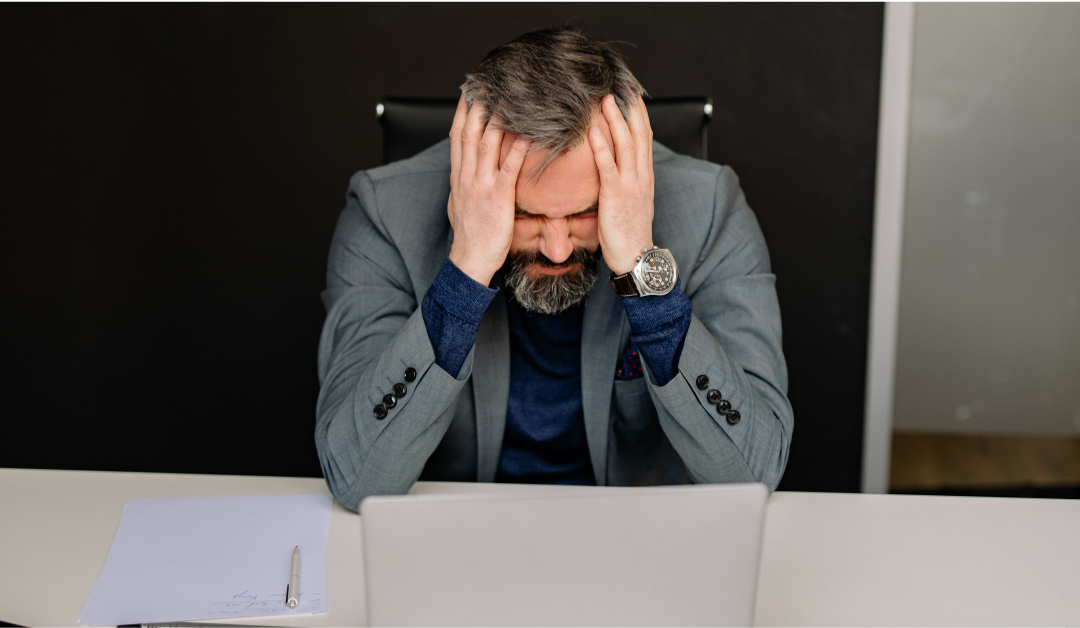 frustrated-executive-sitting-at-desk