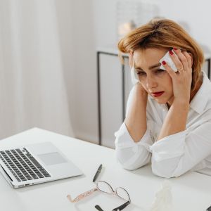 woman upset looking away from her computer