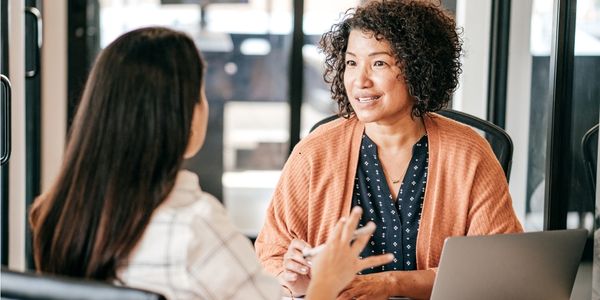 older female executive coaching younger staff member